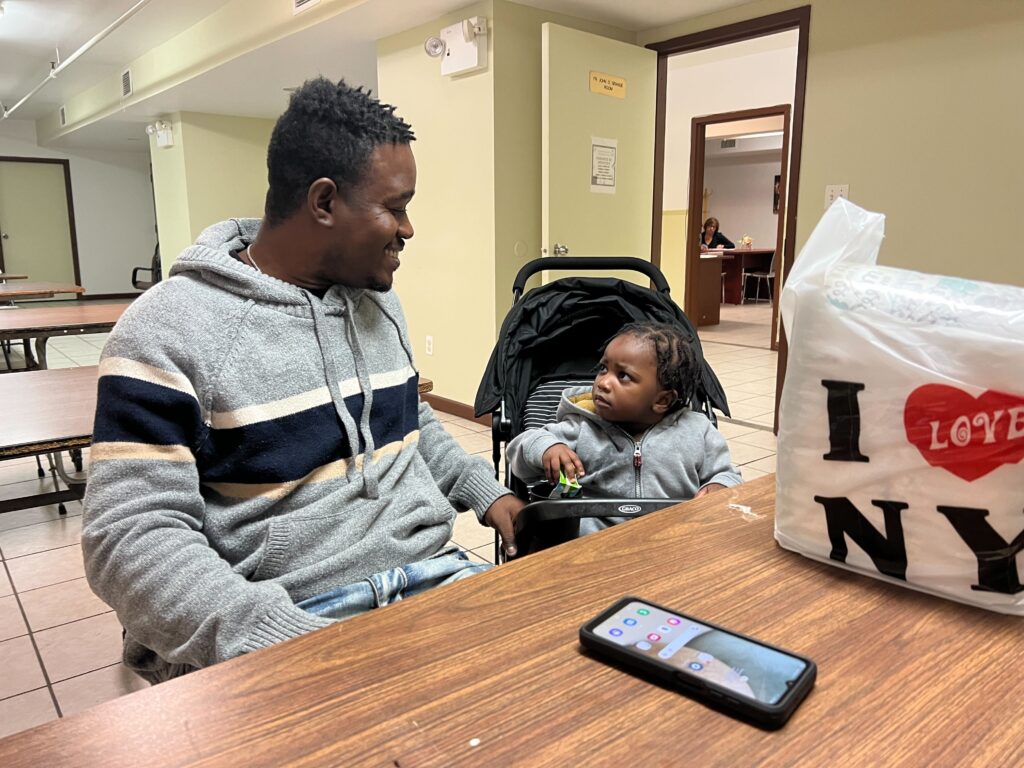 Photo: Jonnathan Pulla.Abdias Providence and his daughter rest at the St. Jerome H.A.N.D.S. community center. Providence hopes to work in construction to support his family.